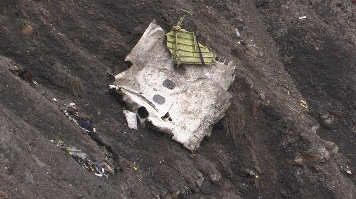 A screengrab taken from an AFP TV video on March 24, 2015 shows search and rescue personnel near scattered debris. (AFP)