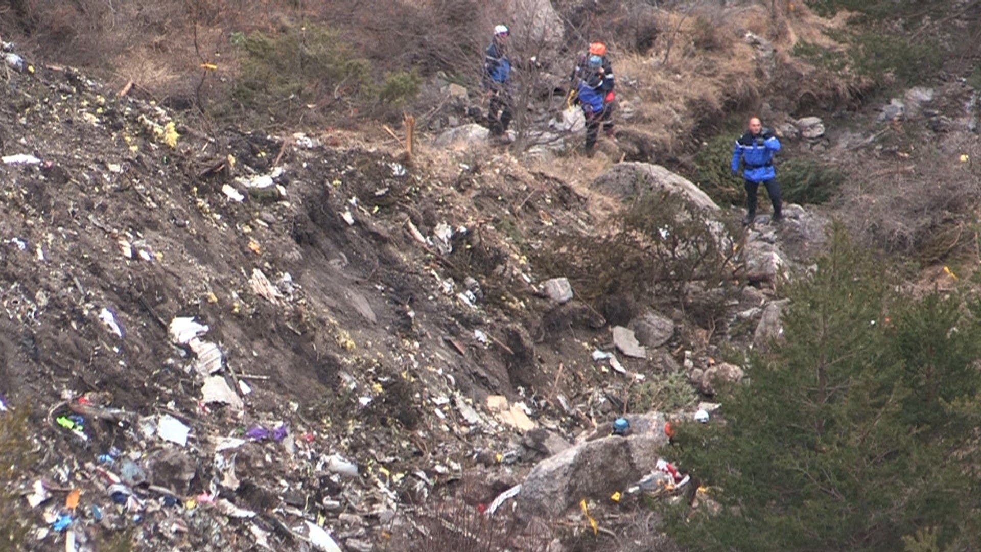 A screengrab taken from an AFP TV video on March 24, 2015 shows search and rescue personnel near scattered debris. (AFP)