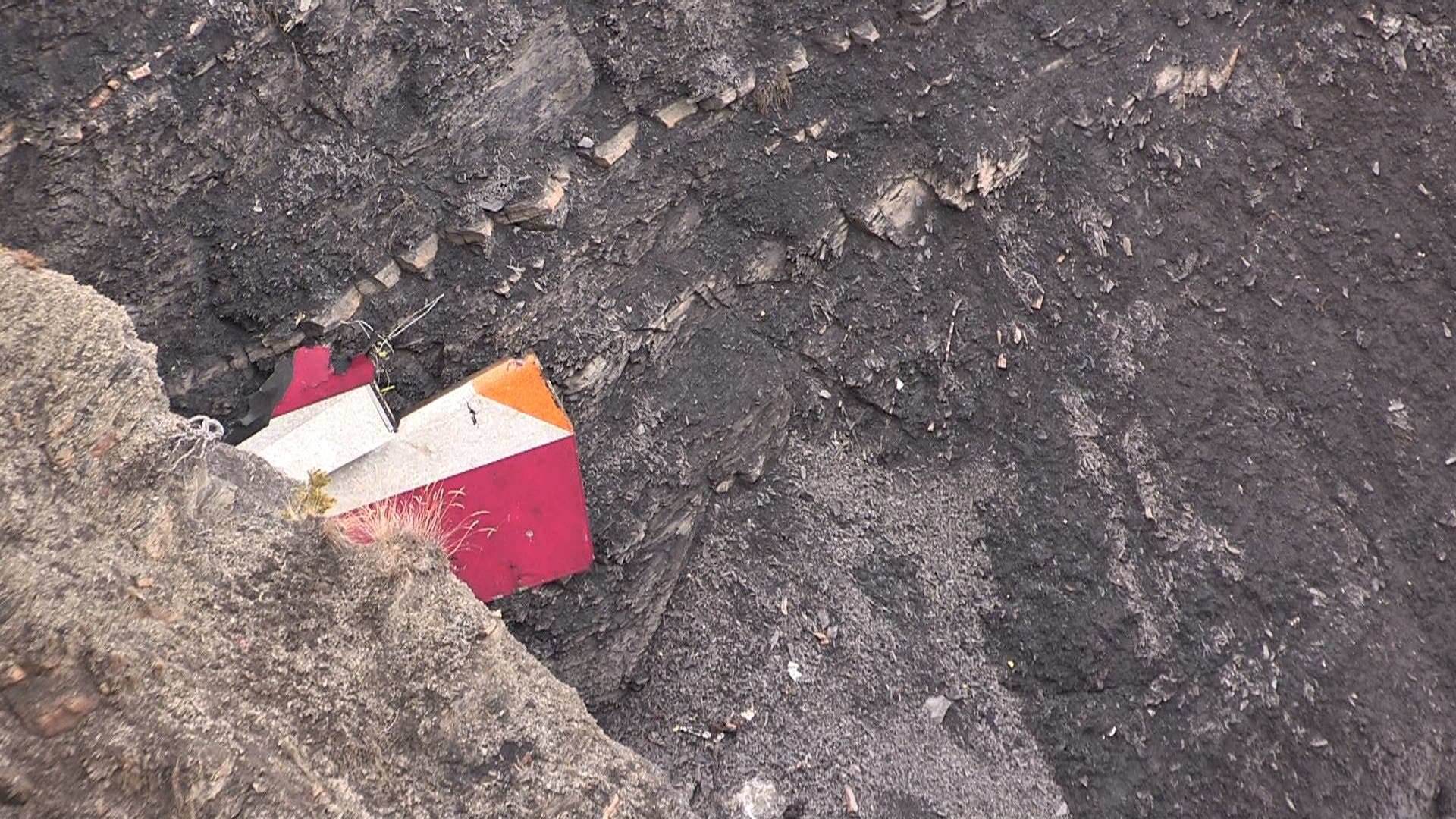 A screengrab taken from an AFP TV video on March 24, 2015 shows search and rescue personnel near scattered debris. (AFP)