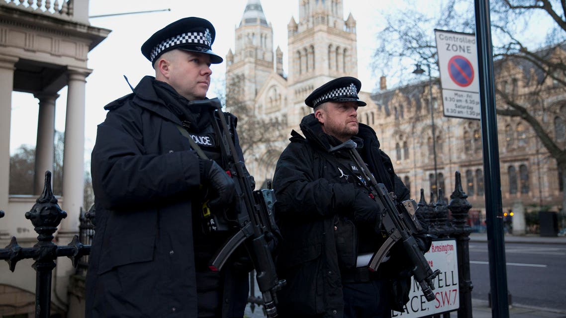 Armed British police officers stand on guard near the French Institute and French School in the South Kensington area of London, on the same day the new edition of French satirical magazine Charlie Hebdo went on sale in France, with copies expected to arrive at vendors to be sold in London on Friday, Wednesday, Jan. 14, 2015. (AP)