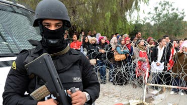 A policeman stands guard as Tunisian demonstrators shout slogans and hold placards during a protest outside Tunisia's Bardo National Museum on March 24, 2015 in Tunis, condemning the attack on the tourist site six days earlier which killed 21 people. (File Photo: AP)