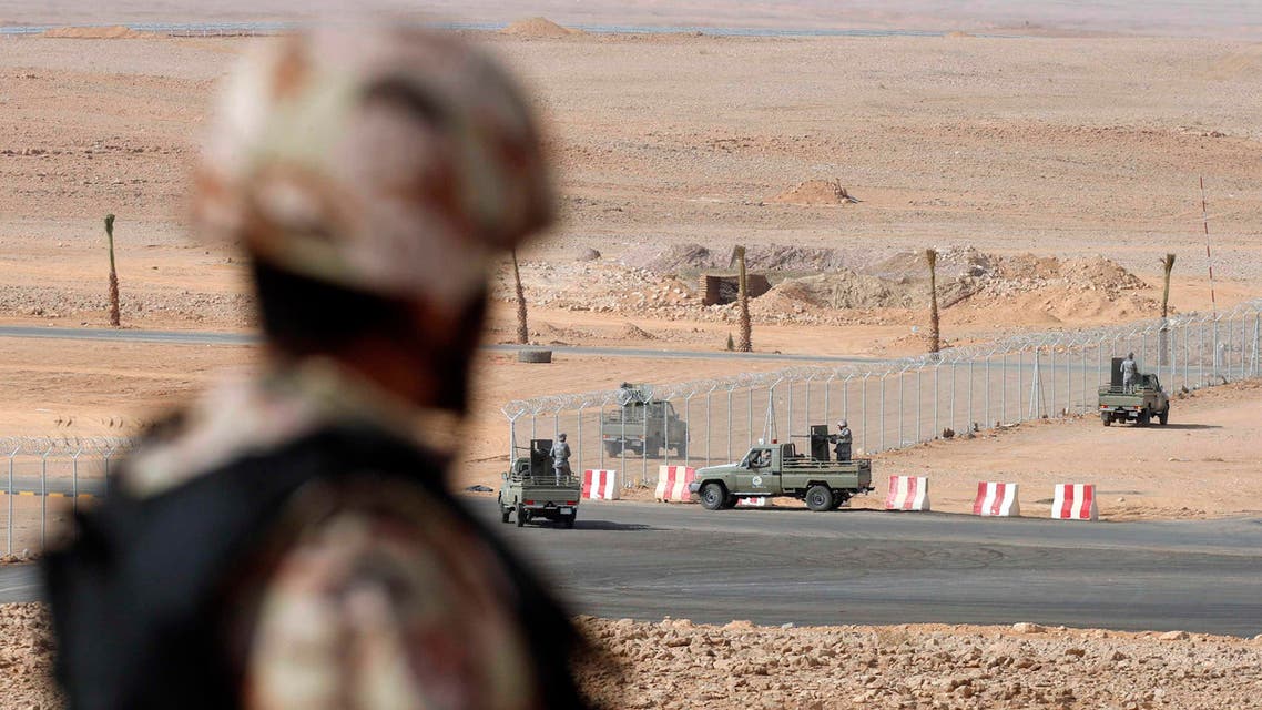 A member of the Saudi security forces stands guard as other demonstrate their skills during a military exercise in Arar, near Saudi Arabia's northern border with Iraq March 18, 2015. (File: Reuters)
