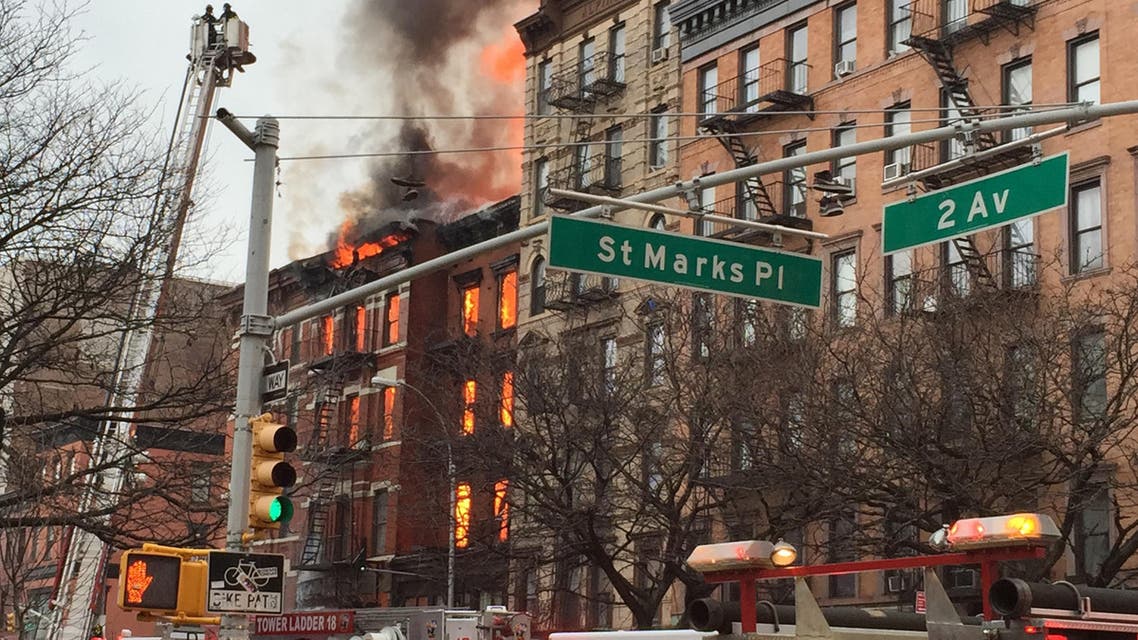 New York City firefighters work the scene of a large fire and a partial building collapse in the East Village neighborhood of New York on Thursday, March 26, 2015. (AP)
