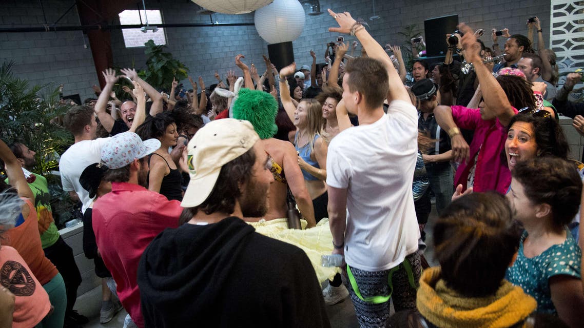 People move on the dance floor at the Daybreaker LA morning dance party, at the Springs in downtown Los Angeles Arts District on March 25, 2015. (AFP)