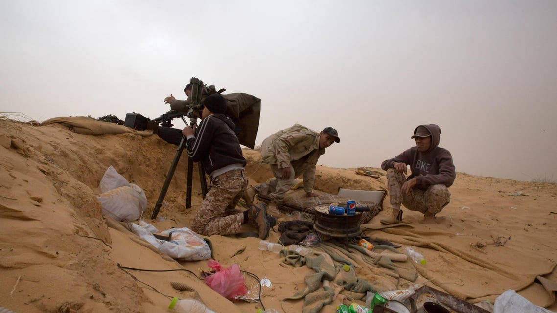 In this Saturday, Feb. 21, 2015 photo, Libyan soldiers aim their weapons during clashes with militants on the frontline in Al Ajaylat, 120 kilometers (75 miles) west of Tripoli. (AP)