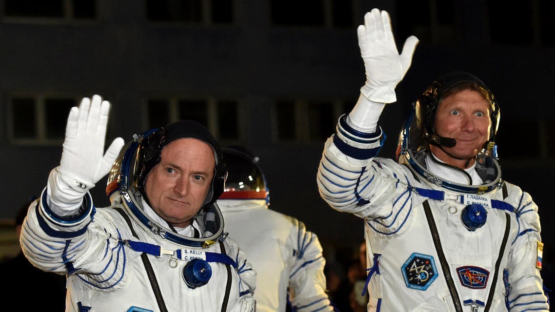 U.S. astronaut Scott Kelly, left, and Russian cosmonaut Gennady Padalka, crew members of the mission to the International Space Station, ISS, wave prior to the launch of Soyuz-FG rocket at the Russian-leased Baikonur cosmodrome, Kazakhstan, Friday, March 27, 2015. AP