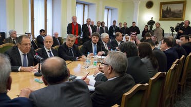 Russian Foreign Minister Sergey Lavrov (L) speaks to participants of consultations between representatives of the Syrian government and the Syrian opposition in Moscow, Jan. 28, 2015. (AP) 