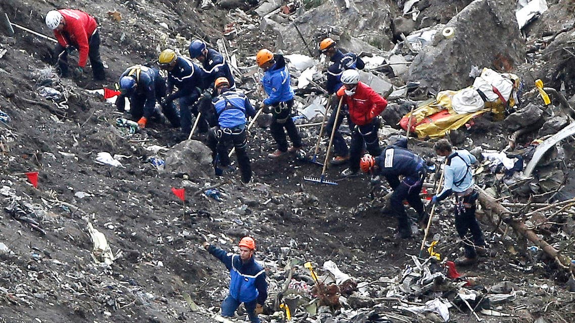 Rescue workers work on debris of the Germanwings jet at the crash site near Seyne-les-Alpes, France, Thursday, March 26, 2015. (AP)
