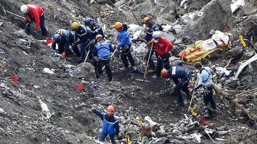 Rescue workers work on debris of the Germanwings jet at the crash site near Seyne-les-Alpes, France, Thursday, March 26, 2015.  (AP)