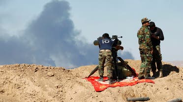 Smoke rises from the Ajil oil field as Shi'ite fighters gather in Al Hadidiya, south of Tikrit, en route to the Islamic State-controlled al-Alam town, where they are preparing to launch an offensive on Saturday, March 6, 2015. (Reuters)