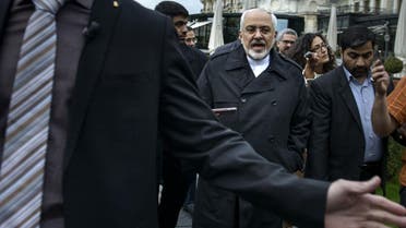 Iranian Foreign Minister Javad Zarif talks to members of the media while walking through a courtyard at the Beau Rivage Palace Hotel during an extended round of talks, Wednesday, April 1, 2015 in Lausanne, Switzerland. (AP)