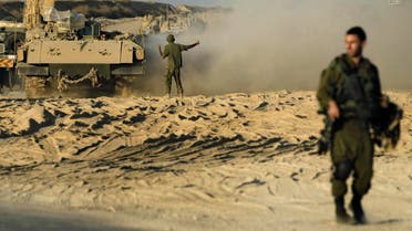 An Israeli solider directs an Armored Personnel Carrier (APC) near the border between Israel and Gaza, Monday, Oct. 28, 2013. (AP)