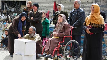 Residents wait to receive humanitarian aid at the Palestinian refugee camp of Yarmouk, in Damascus March 11, 2015. (Reuters)