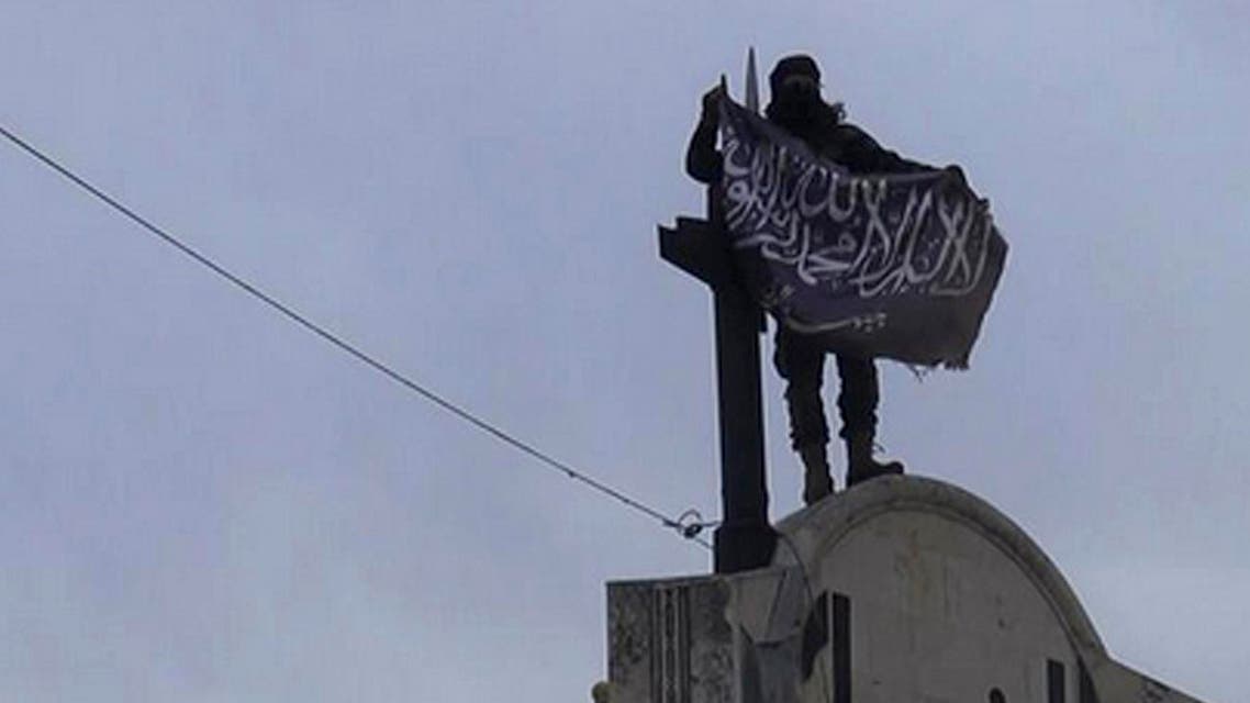 [Window Title] Enter name of file to save to…  [Content] In this image posted on the Twitter page of Syria's al-Qaida-linked Nusra Front on Saturday, March 28, 2015, which is consistent with AP reporting, a fighter from Syria's al-Qaida-linked Nusra Front holds his group flag in Idlib province, north Syria. (AP) The path is too long. Try a shorter name.  [OK]