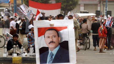 A supporter of Yemen's former president Saleh holds up his portrait during a rally against Saudi-led coalition airstrikes in Sanaa. (Reuters)