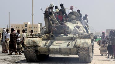 Tribesmen stand on a tank they took from an army base in Shihr city of Yemen's eastern Hadramawt province. (Reuters)
