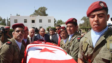 Tunisia's President Moncef Marzouki, center, helps carrying the coffin of a soldier during a ceremony in Kasserine, Tunisia, Tuesday, July, 30, 2013. 