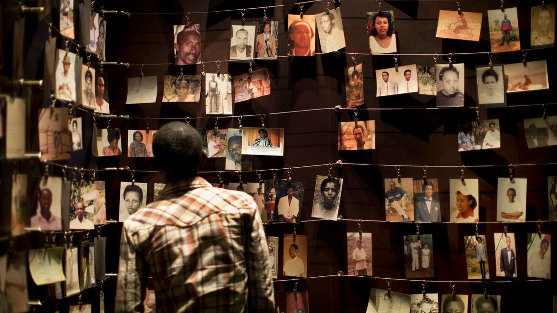 A visitor observes a display of family photographs of some of those who died, in the Kigali Genocide Memorial Centre in Kigali, Rwanda Saturday, April 5, 2014. (AP)
