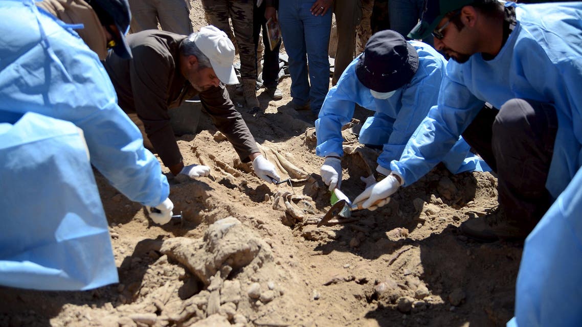 Members from the Iraqi forensic team search to extract the remains of the bodies belonging to Shi'ite soldiers from Camp Speicher who have been killed by Islamic State militants at a mass grave in Tikrit. Reuters 