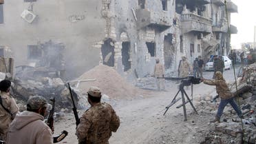 Members of the Libyan pro-government forces, backed by the locals, with weapons are seen during clashes in the streets with Shura Council of Libyan Revolutionaries, an alliance of former anti-Gaddafi rebels who have joined forces with Islamist group Ansar al-