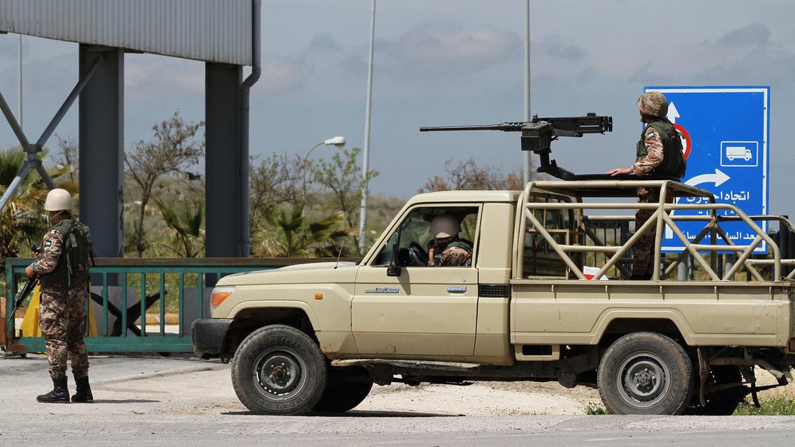 Members of the Jordanian government forces stand guard at the Nasib crossing in the town of Jaber, north of Mafraq, Jordan, Thursday, April 2, 2015. Syrian rebels and fighters from the al-Qaida-affiliated Nusra Front have captured the only functioning border crossing with Jordan and three nearby military posts, prompting intense government bombing raids of the area, activists said Thursday. The Jordanian government had closed the crossing since Tuesday night for security reasons. (AP Photo/Raad Adayleh)