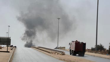 A fire truck drives towards smoke caused by an attack by Islamist militias during clashes with forces led by renegade Libyan Gen. Khalifa Hifter in Benghazi, Libya, Wednesday, Oct. 15, 2014. Islamist militias fought Wednesday with forces loyal to Hifter, who vows to seize the eastern city of Benghazi, as a top militia commander accused Egypt of bombing his positions with warplanes. (AP Photo/Mohammed el-Sheikhy)