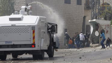 An Israeli police vehicle sprays water during clashes with Palestinians in Beit Omar village near the West Bank city of Hebron April 10, 2015. (Reuters)