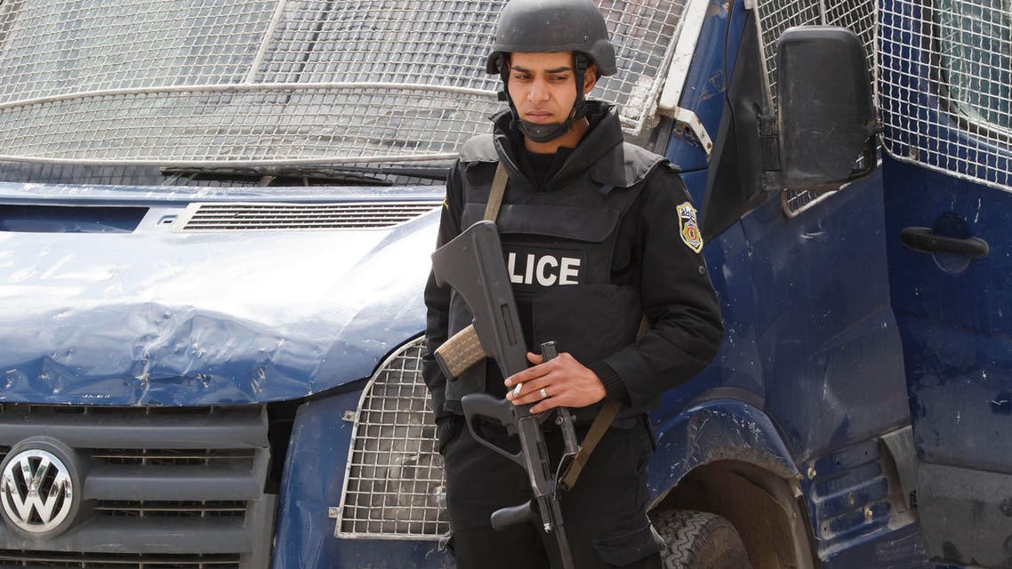 An armed Tunisian police officer, stands guard at the morgue of the Charles Nicolle hospital in Tunis, Tunisia, Friday, March 20, 2015. The two extremist gunmen who killed 21 people at a museum in Tunis trained in neighboring Libya before caring out the deadly attack, a top Tunisian security official said. (AP Photo/Michel Euler)