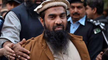 In this photograph taken on January 1, 2015 Pakistani security personnel escort Zaki-ur-Rehman Lakhvi (C), alleged mastermind of the 2008 Mumbai attacks, as he leaves the court after a hearing in Islamabad. (File: AFP)