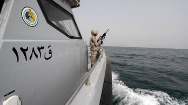 Saudi border guard watches as he stands in boat off coast of Red Sea on Saudi Arabia's maritime border with Yemen, near Jizan Reuters