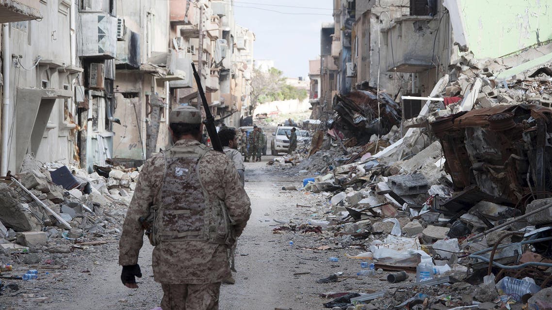 Members of Libyan pro-government forces walk with weapons during clashes in the streets with the Shoura Council of Libyan Revolutionaries, in Benghazi April 1, 2015. (Reuters)