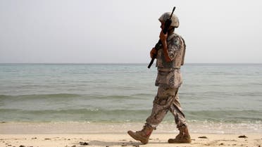 A Saudi border guard patrols near Saudi Arabia's border with Yemen, along beach on Red Sea, near Jizan 