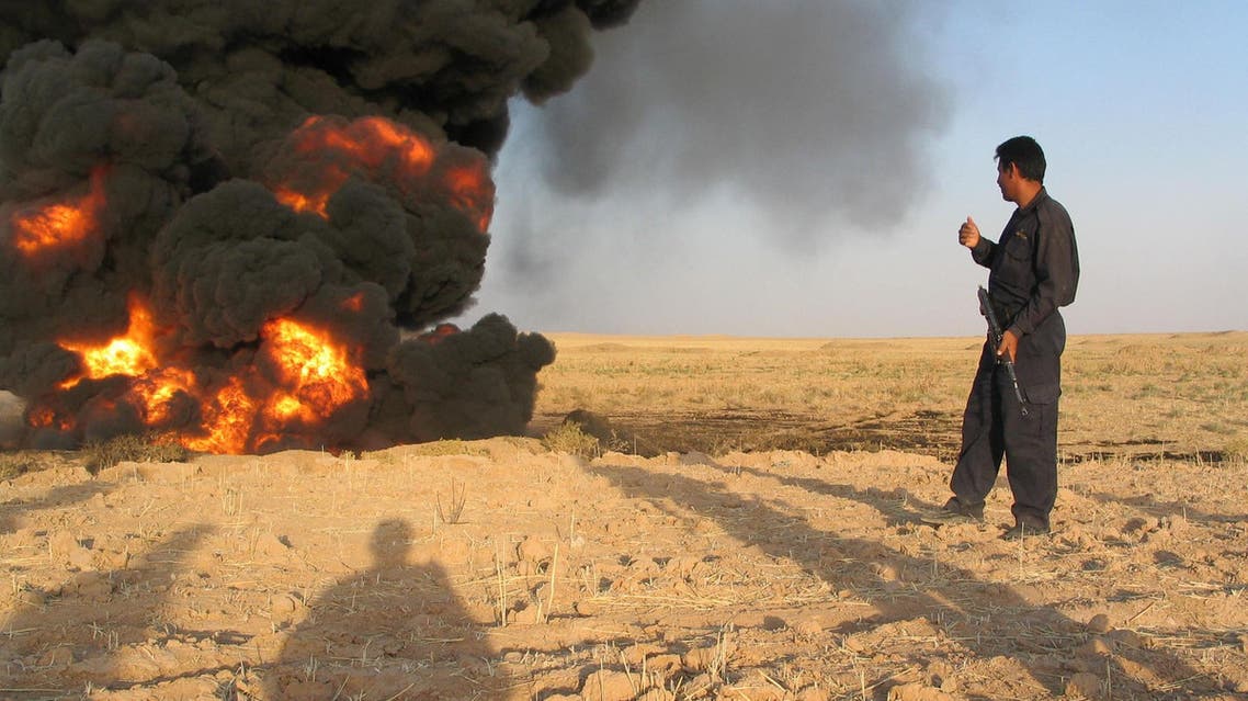 An Iraqi pipeline security guard inspects a damaged oil pipeline caused by a bomb explosion, Thursday, Aug. 4, 2005, in the northern town of Kirkuk, 200 kms. (124 miles) north of Baghdad, Iraq. The pipeline passes by Kirkuk toward the Baiji refineries. ap