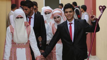 Palestinian bride Marwa Mousa and her groom Ahmed Abu Salama take part in a mass wedding ceremony in Gaza City, on April 11, 2015. (AFP)