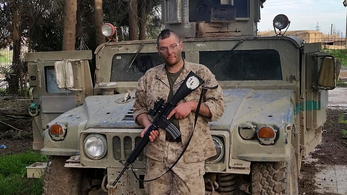 In this Feb. 26, 2015 photo, Jamie Lane, 29, an American veteran originally from Mt. Pleasant Michigan, poses for a picture in front of an Iraqi Army Humvee captured and later abandoned by Islamic State militants in Tel Hamis, Syria. Lane is among growing number of Iraq war veterans returning to the battlefield, this time without the American military, to join in the fight against the Sunni militants who now hold territory in a third of Iraq and Syria. (Courtesy Jamie Lane via AP)