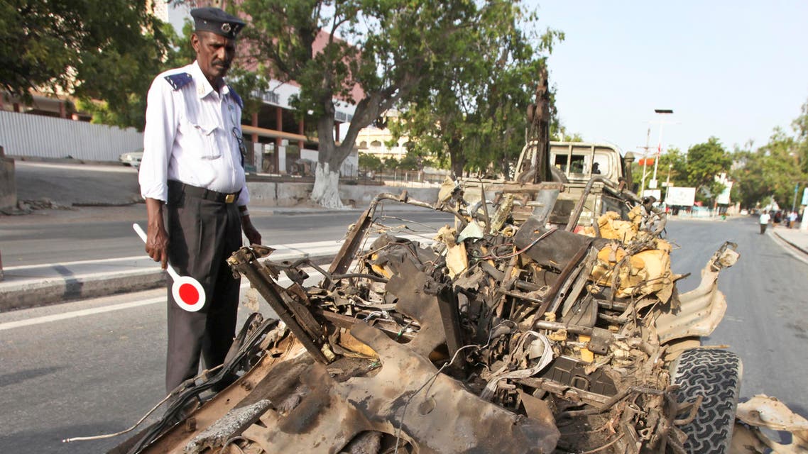 A Somali traffic policeman stands near the wreckage of a suicide car bomb in Mogadishu, Somalia Thursday, Jan. 22, 2015. (File Photo: AP)