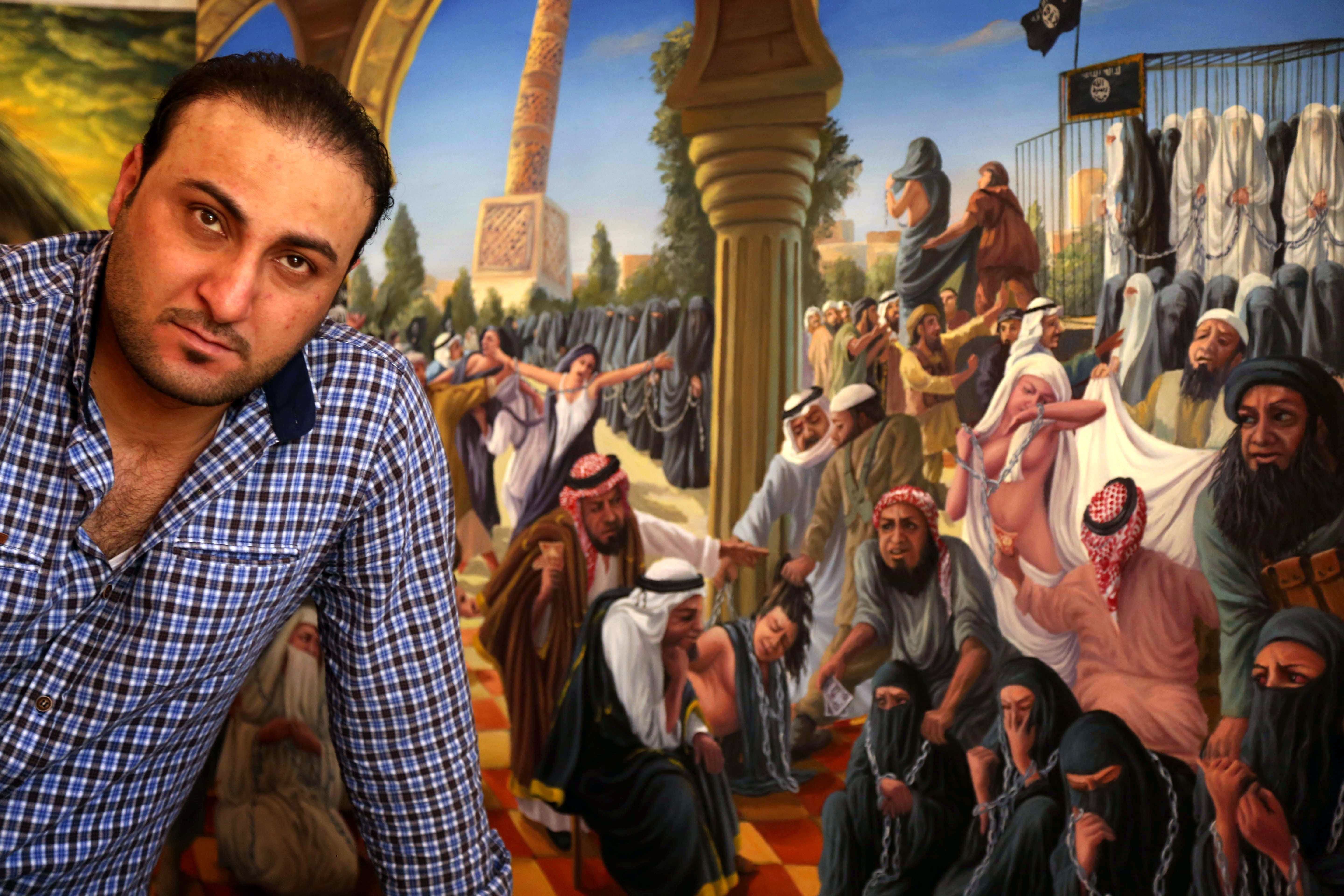 Iraqi painter Ammar Salim poses near one of his art pieces at his workshop in the Iraqi Kurdish city of Dohuk, on March 26, 2015. AFP