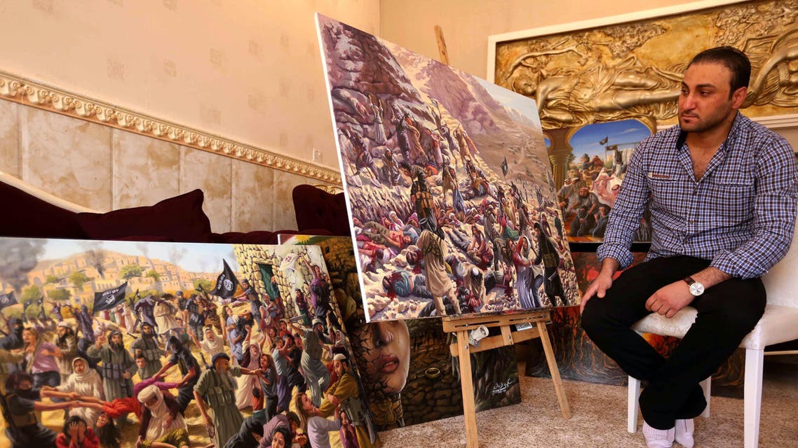 Iraqi painter Ammar Salim poses near some of his art pieces at his workshop in the Iraqi Kurdish city of Dohuk, on March 26, 2015. (AFP)