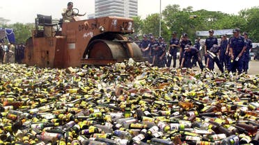 Government officials use a steamroller to destroy thousands of bottles of liquor and spirits confiscated from unlicensed stores in Jakarta, Indonesia. (File Photo: AP)