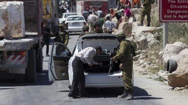  An Israeli soldier searches a Palestinian vehicle at a checkpoint near Hebron. (File: Reuters)