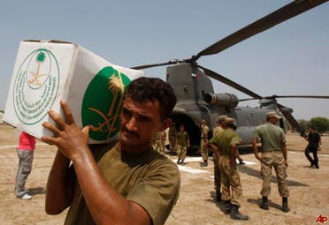  A Pakistani soldier carries aid supplies from Saudi Arabia, in Retra town about 55 kms north west of Multan, Pakistan, Wednesday, Aug. 18, 2010. (AP Photo/Kamran Jebreili)