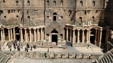 Rebel fighters walk inside a 2nd century Roman amphitheater in the historic Syrian southern town of Bosra al-Sham, after they took control of the area March 25, 2015. Reuters