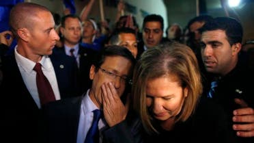 Isaac Herzog (L) speaks with Tzipi Livni, his co-leader of the center-left Zionist Union party, while campaigning outside a polling station in Modiin near Tel Aviv March 17, 2015. (AP)