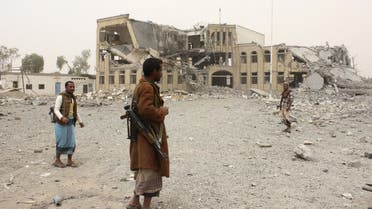 Police troopers stand near the building of police headquarters, destroyed by Saudi-led air strikes, in Yemen's northwestern city of Saada. (Reuters)