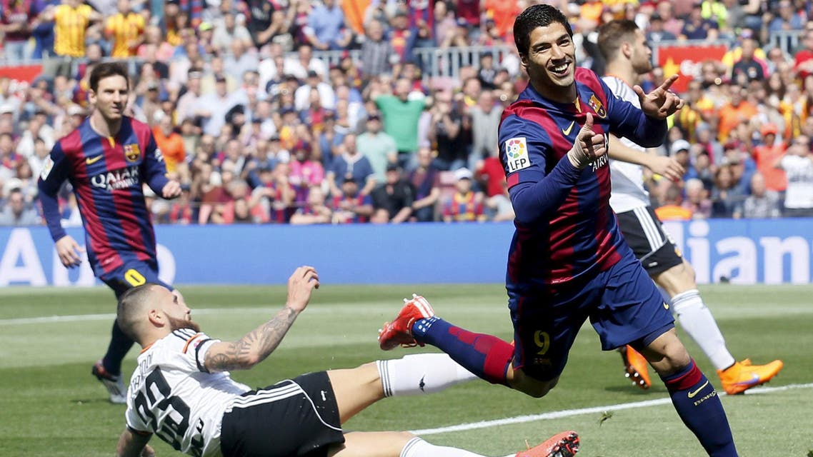 Barcelona's Luis Suarez (R) celebrates a goal against Valencia's Otamendi during their Spanish first division soccer match at Camp Nou stadium in Barcelona April 18, 2015. reuters