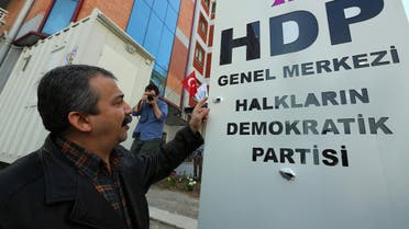 Sirri Sureyya Onder, a lawmaker, shows bullet traces after assailants opened fire on the headquarters of the pro-Kurdish Peoples’ Democratic Party, HDP, in Ankara, early Saturday Turkey, April 18, 2015. (AP)