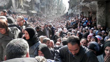 Refugees in Yarmouk queue for food (AP)