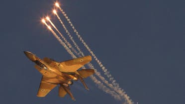 An Israeli Air Force F15I fighter jet releases flares during an acrobatics display during a graduation ceremony at the Hatzerim Air Force base near the southern city of Beersheba, Israel,Thursday, June 28, 2012.  (AP)