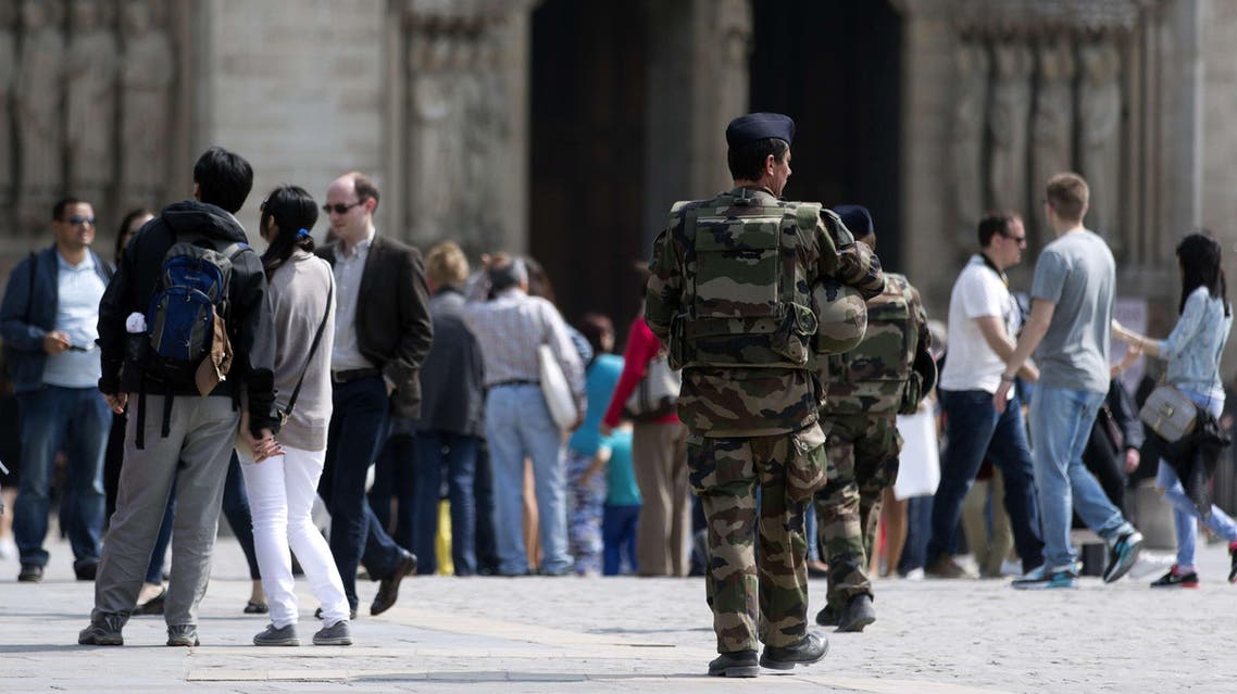 French soldiers patrol near the Notre-Dame cathedral in Paris on April 24, 2015. Sid Ahmed Ghlam, 24, was being questioned for a fifth day after his custody was extended under special French anti-terror laws which allow police to interrogate a suspect for up to six days if there is a "risk of an imminent attack".Paris is still on high alert after the jihadist killing spree on Charlie Hebdo magazine and other targets around Paris that left 17 people dead, and in the wake of a foiled plot to carry out attacks on churches, Interior Minister Bernard Cazeneuve has ordered authorities to step up security around churches. AFP PHOTO KENZO TRIBOUILLARD