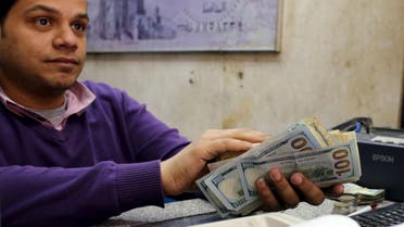 An employee counts money in a foreign exchange office in central Cairo, April 15, 2015. Reuters